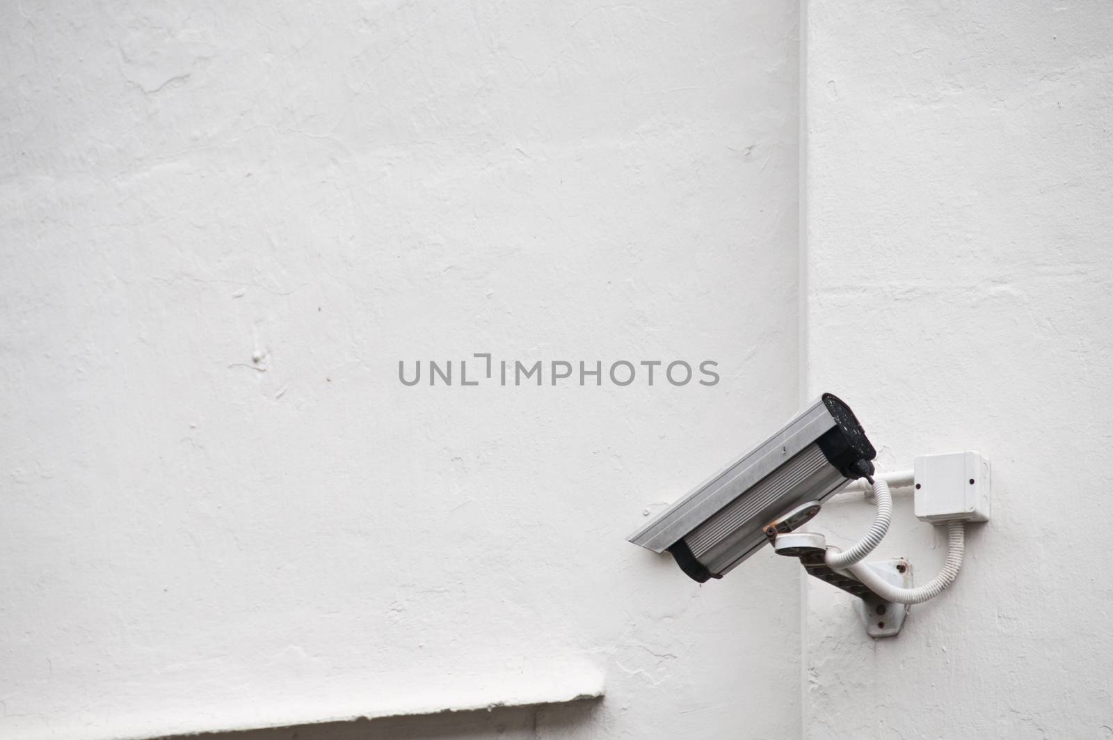 Surveillance camera on a wall by eyeofpaul