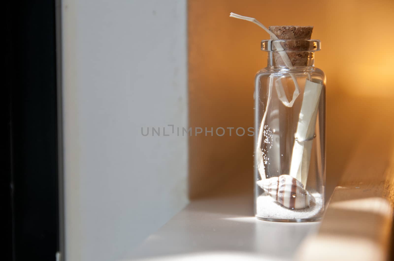 Little strip message in a bottle of sand and shell by eyeofpaul