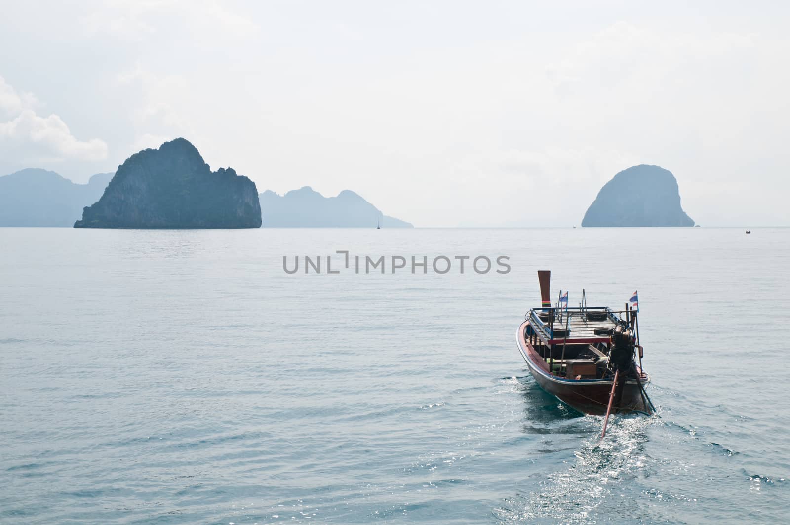 Thai boat sailing in Phuket sea by eyeofpaul