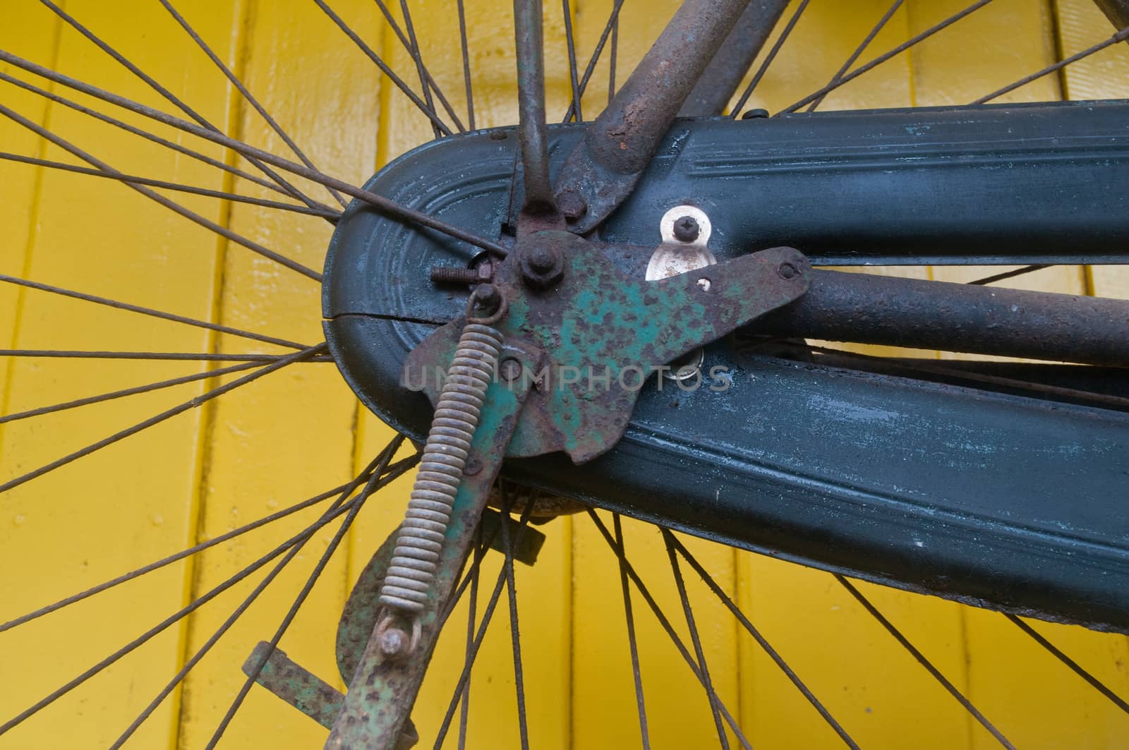 Classical bike engine on yellow wall by eyeofpaul