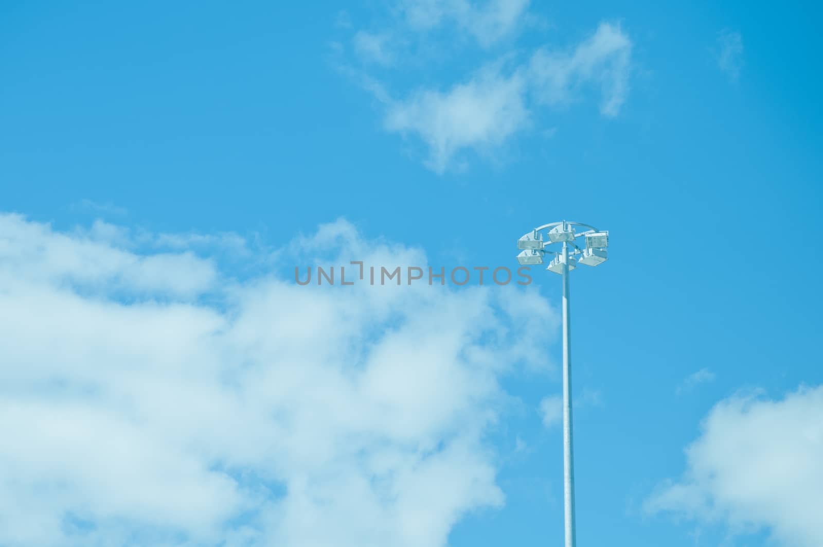 Spotlight pole and blue clear sky
