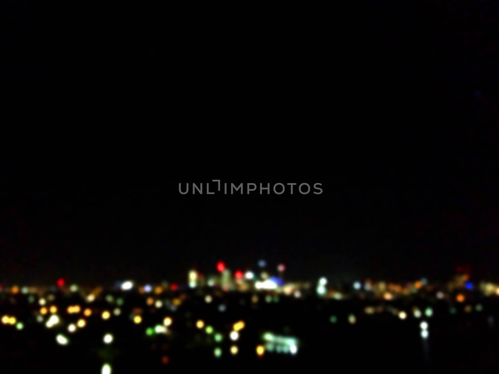 Defocused blurry night scene of abstract city light at midnight