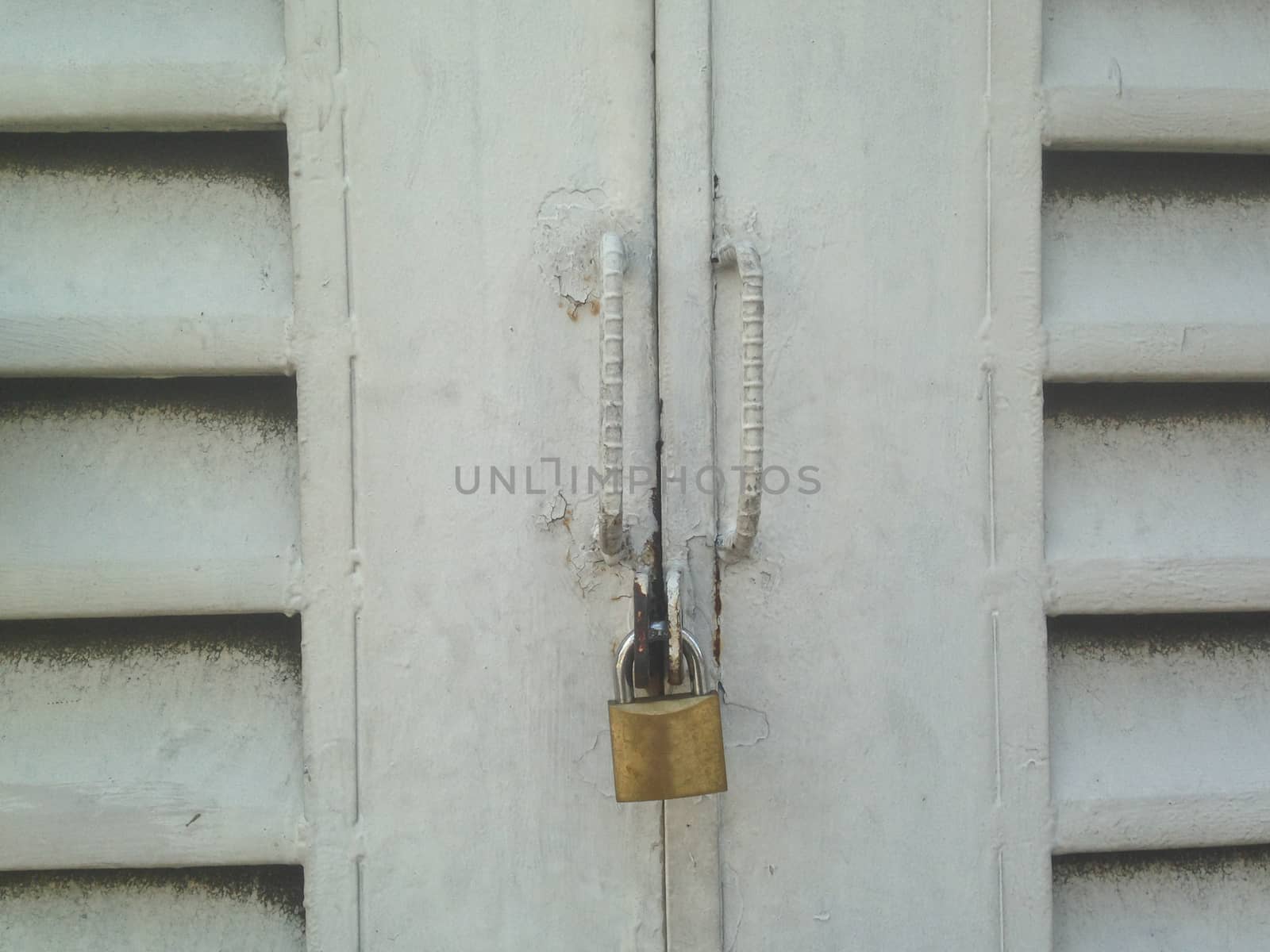 Vintage closed door with golden lock by eyeofpaul