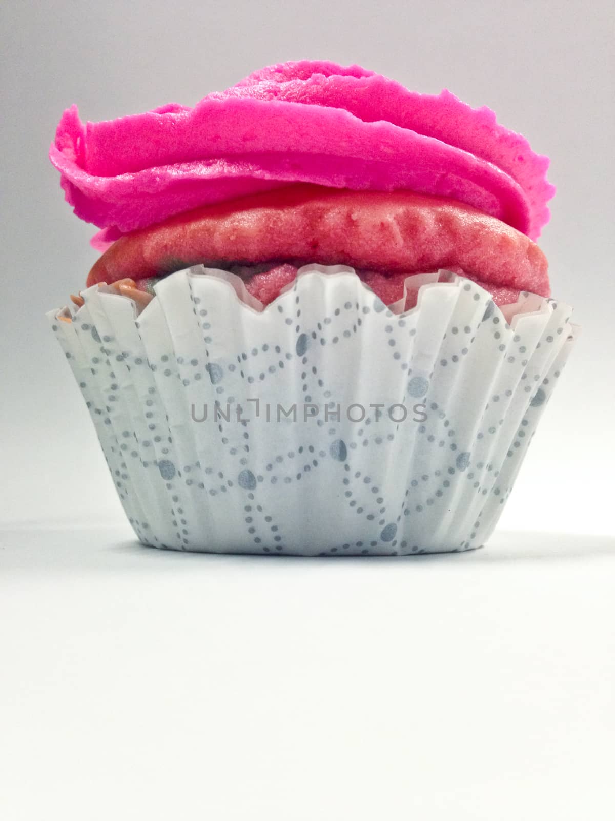 Pink cup cake home made verticle view by eyeofpaul