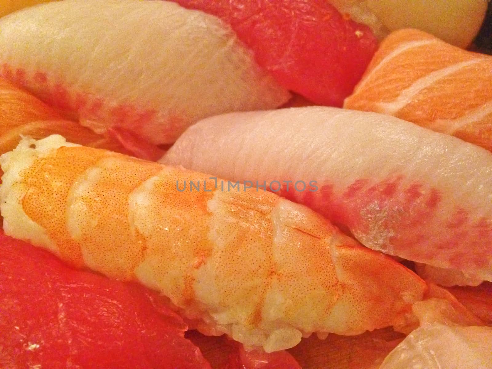 Mixed fresh Japanese sushi platter served on wooden plate and eat with chopsticks