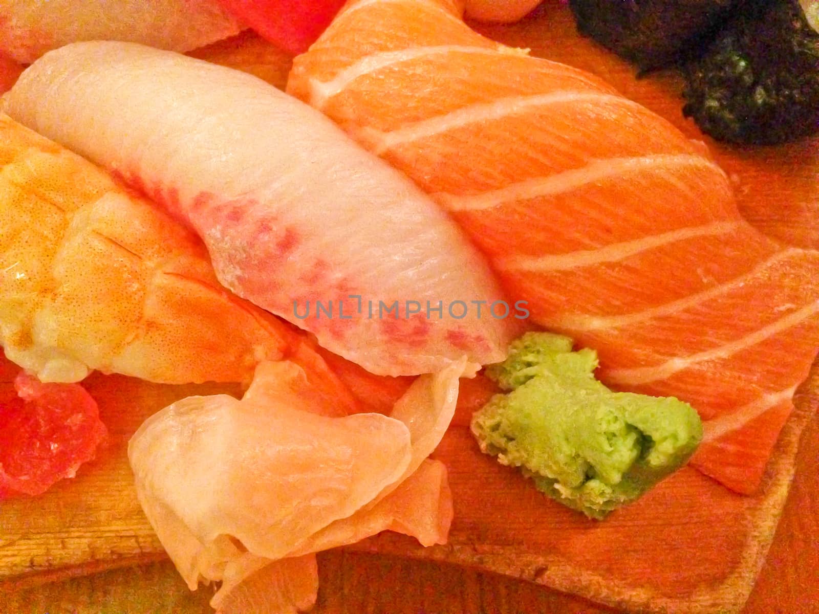 Mixed fresh Japanese sushi platter served on wooden plate by eyeofpaul