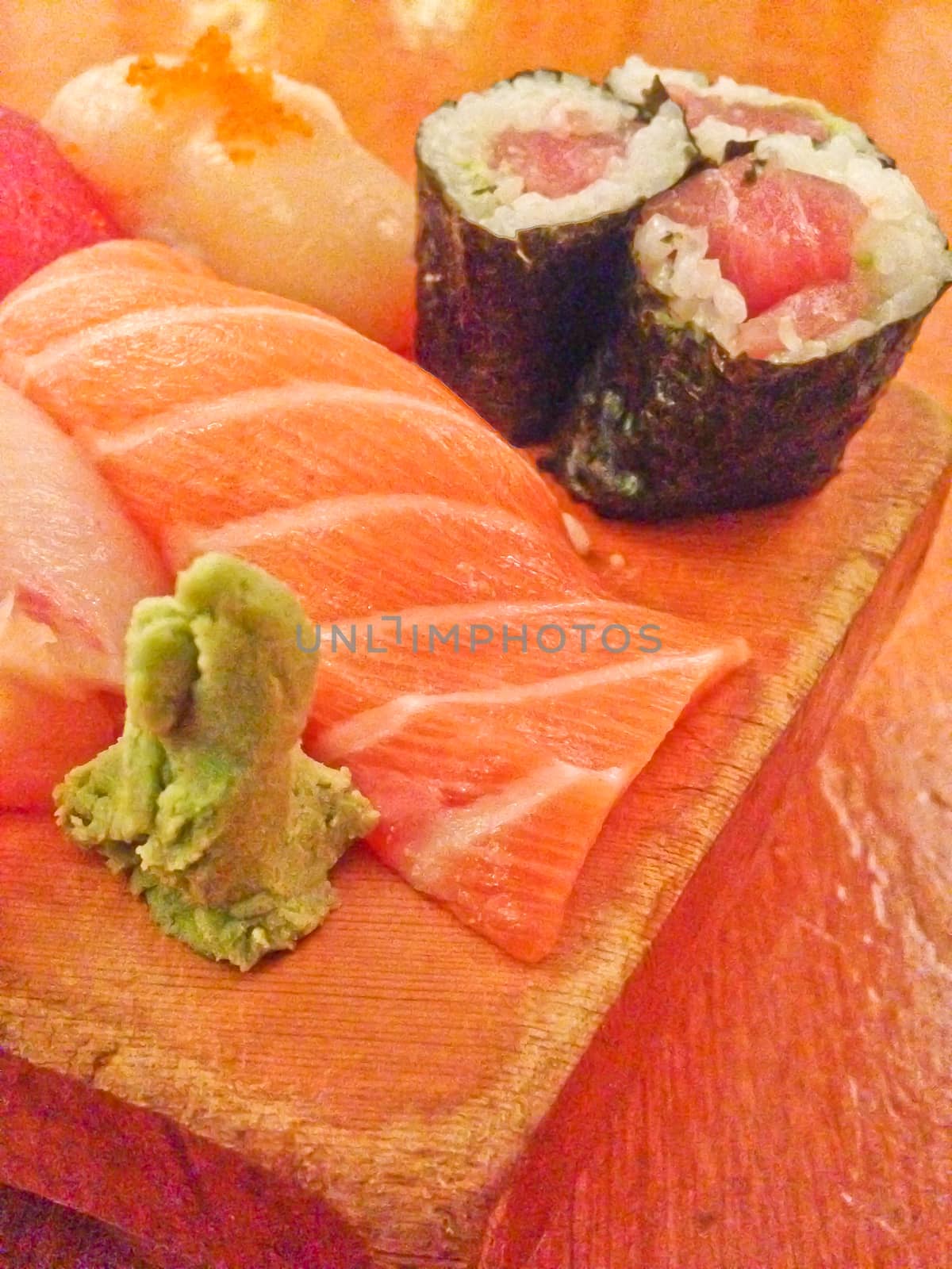 Mixed fresh Japanese sushi platter served on wooden plate by eyeofpaul