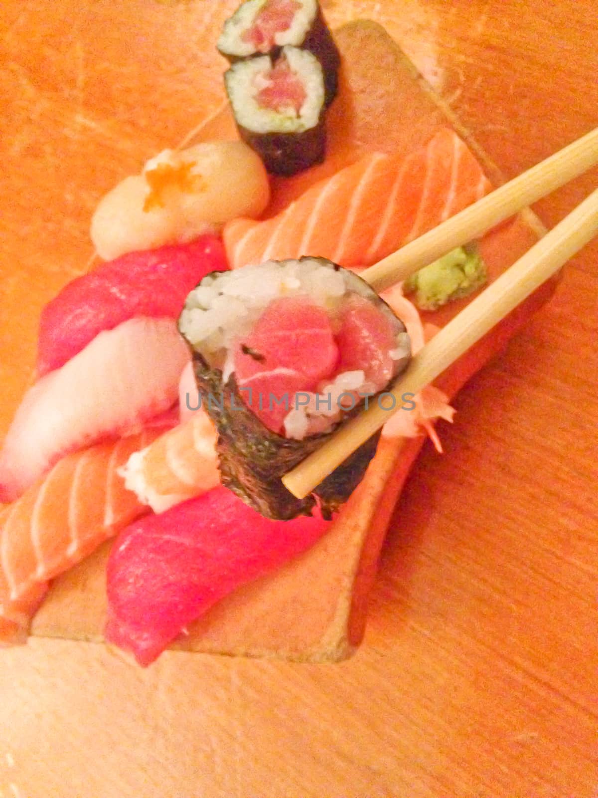 Mixed fresh Japanese sushi platter served on wooden plate by eyeofpaul