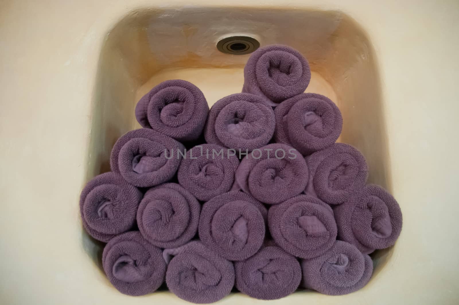 Purple towel rolls in a closet wall by eyeofpaul