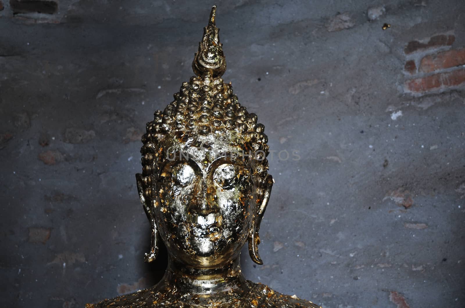 Golden Buddha statue face by eyeofpaul