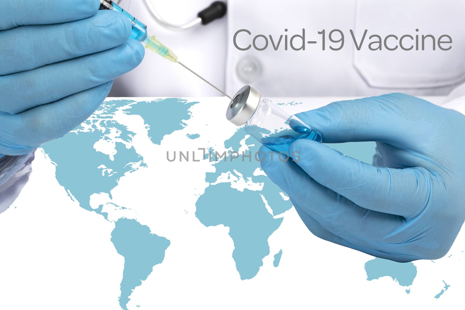 A doctor in white coat sitting at a desk with blue world map drawing blue liquid from a glass vial. World wide Covid 19 vaccination concept.