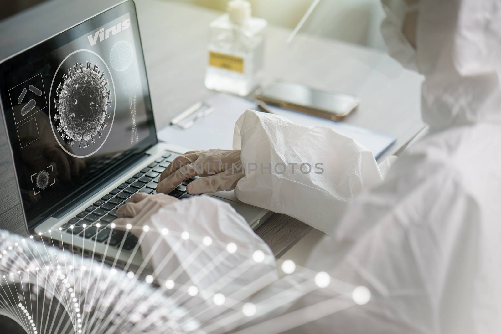 Woman in protective hazmat suit worker in laboratory computer analyzing in laboratory. to stop spreading coronavirus or COVID-19.