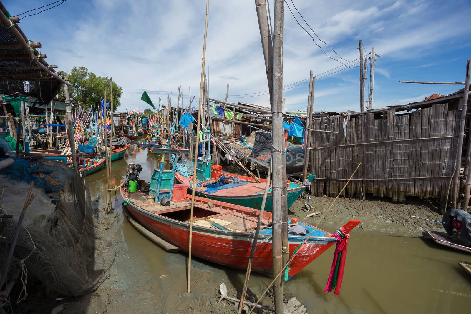 Thai small fishing boats have docked at fishing village at day time.