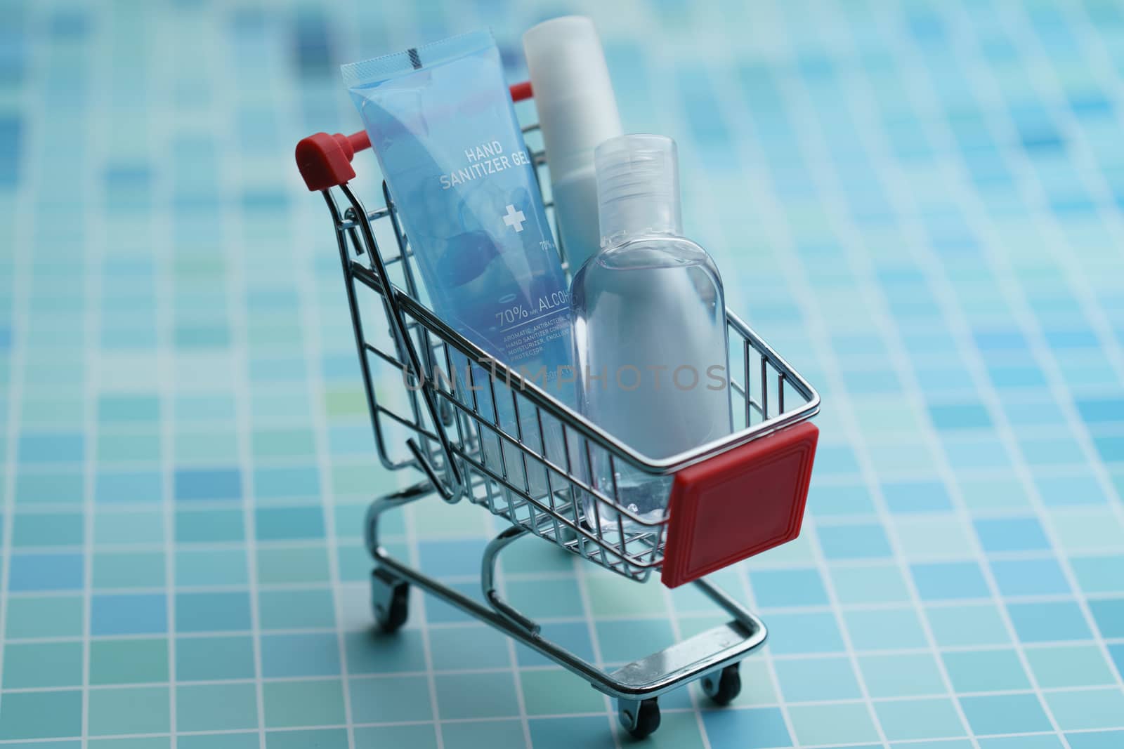 Shopping cart with must have items hand sanitizer, corona virus or Covid-19 protection.