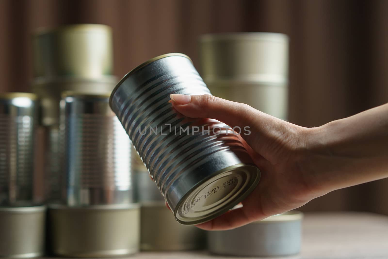 Woman hand with group of Aluminium canned food. by sirawit99