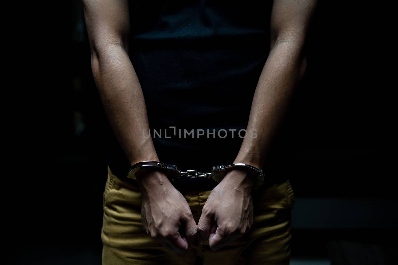 Handcuffed on a prisoner, Male prisoners were handcuff in the dark prison.