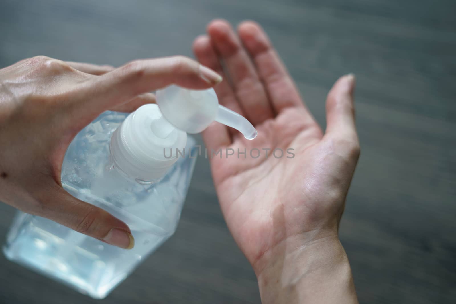 Woman washing hands with alcohol gel or sanitizer gel. corona vi by sirawit99