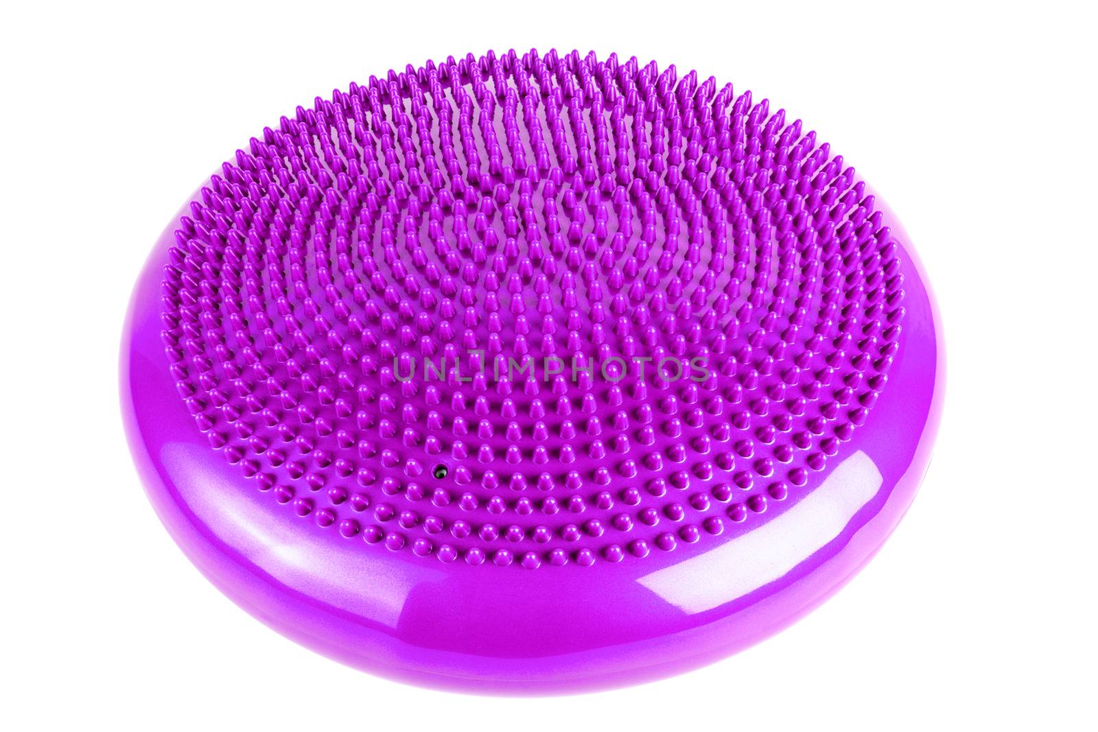 Purple inflatable balance disk isoleated on white background. A balance disk is a cushion can be used in fitness training as the base for core, balance, and stretching exercises. It is also known as a stability disc, wobble disc, and balance cushion.
