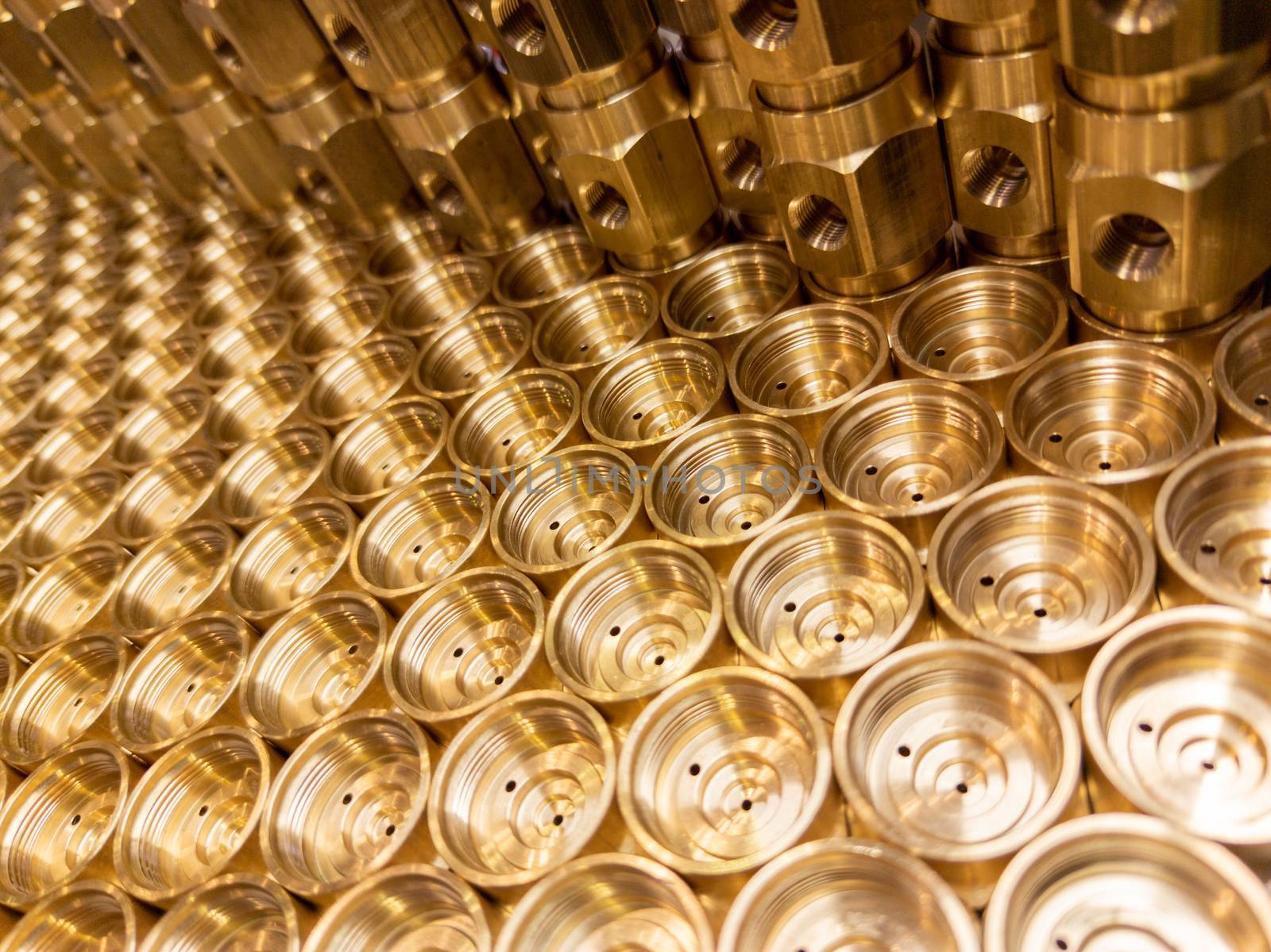 shiny brass metal threaded hexagonal fitting parts, abstract perspective industrial close-up background.