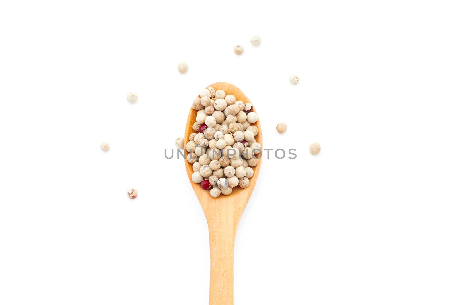 Pepper spices in a wooden spoon on a white background   by sompongtom