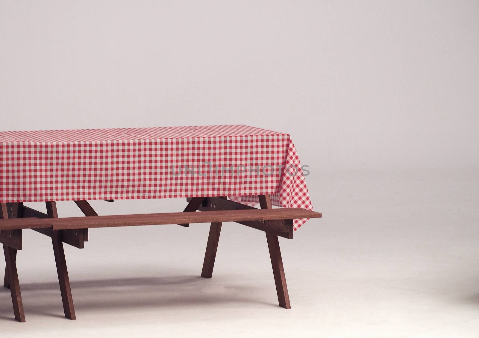 Wood table and red napkin for outdoor party and white background.