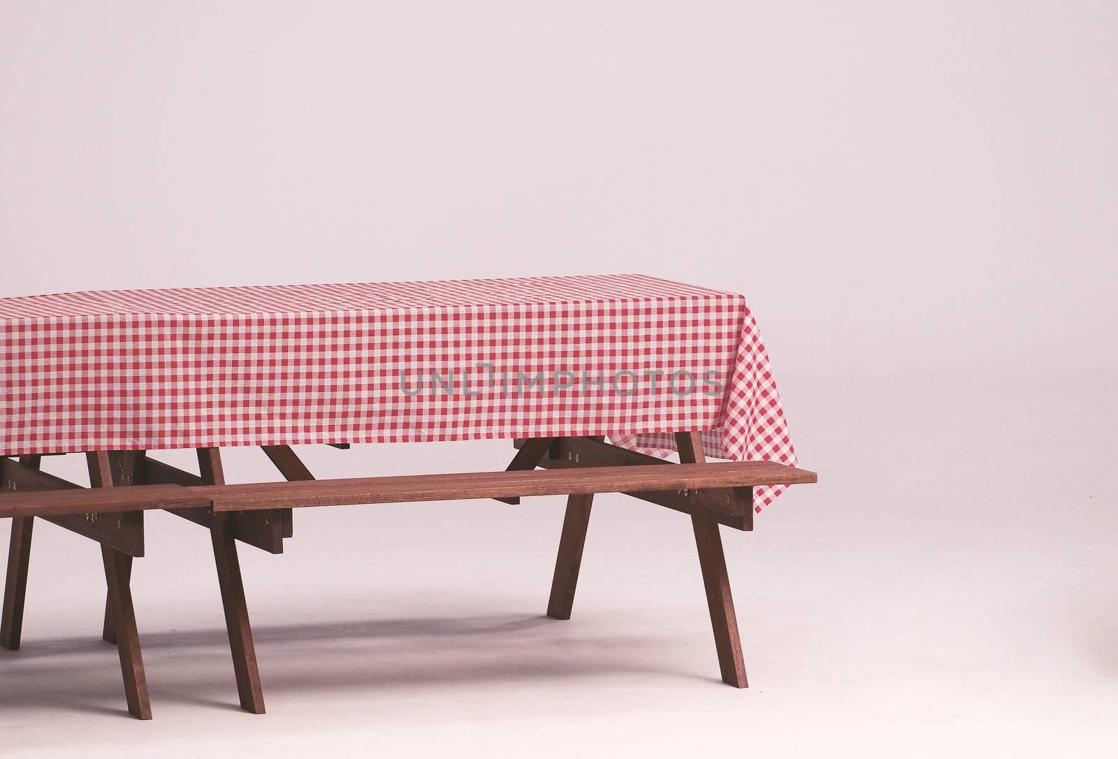 Wood table and red napkin for outdoor party and white background.