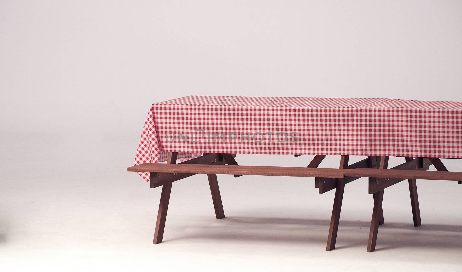 Wood table and red napkin for outdoor party. by gnepphoto