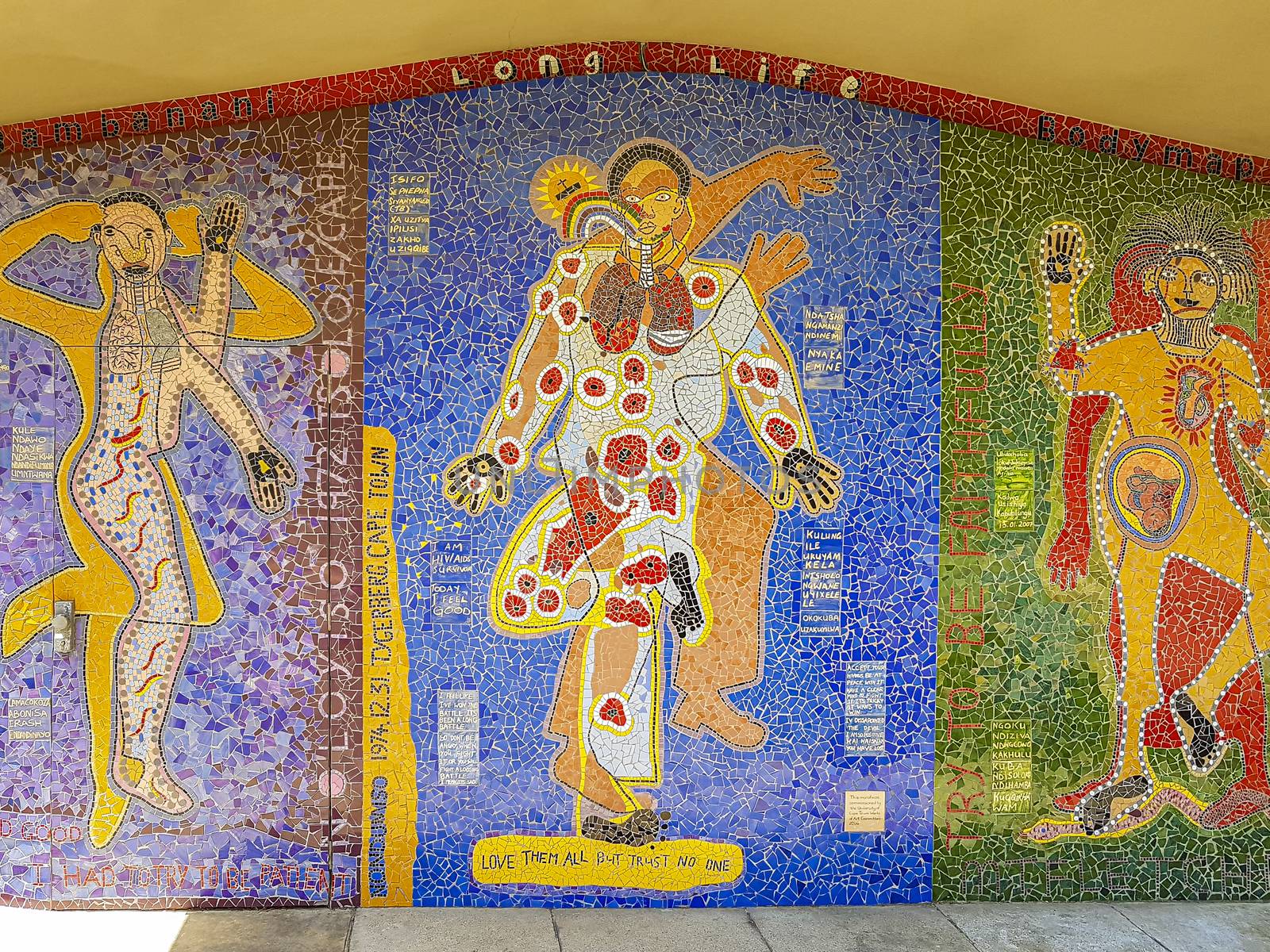 Colorful LONG LIFE artwork made of colorful mosaic on wall. by Arkadij