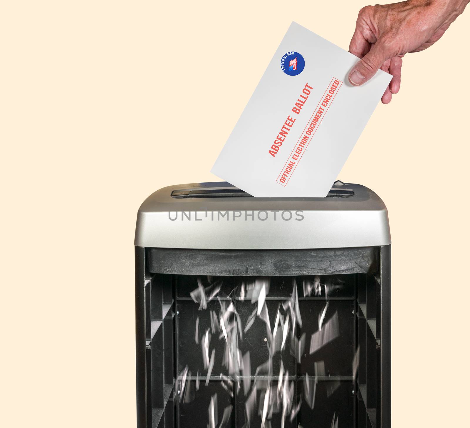 Absentee ballot voteing by mail envelope being shredded in office paper shredder as concept for voting fraud or lost votes in Presidential election