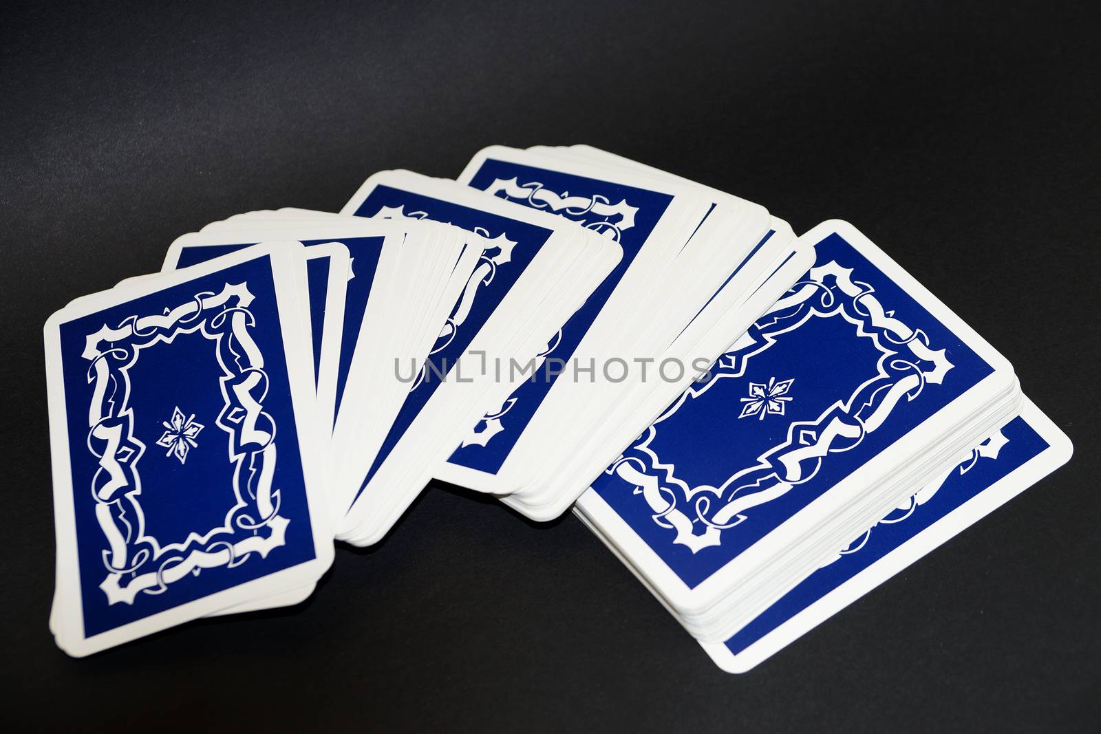 unfolded deck of tarot cards on black background lose up