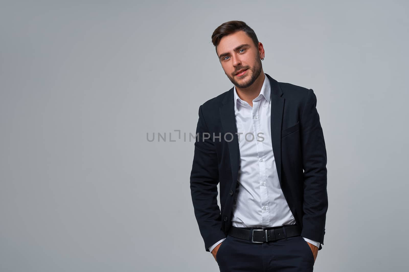 Businessman Business person. Man business suit studio gray background. Modern business person stylish haircut earring in ear. Portrait of charming successful young entrepreneur