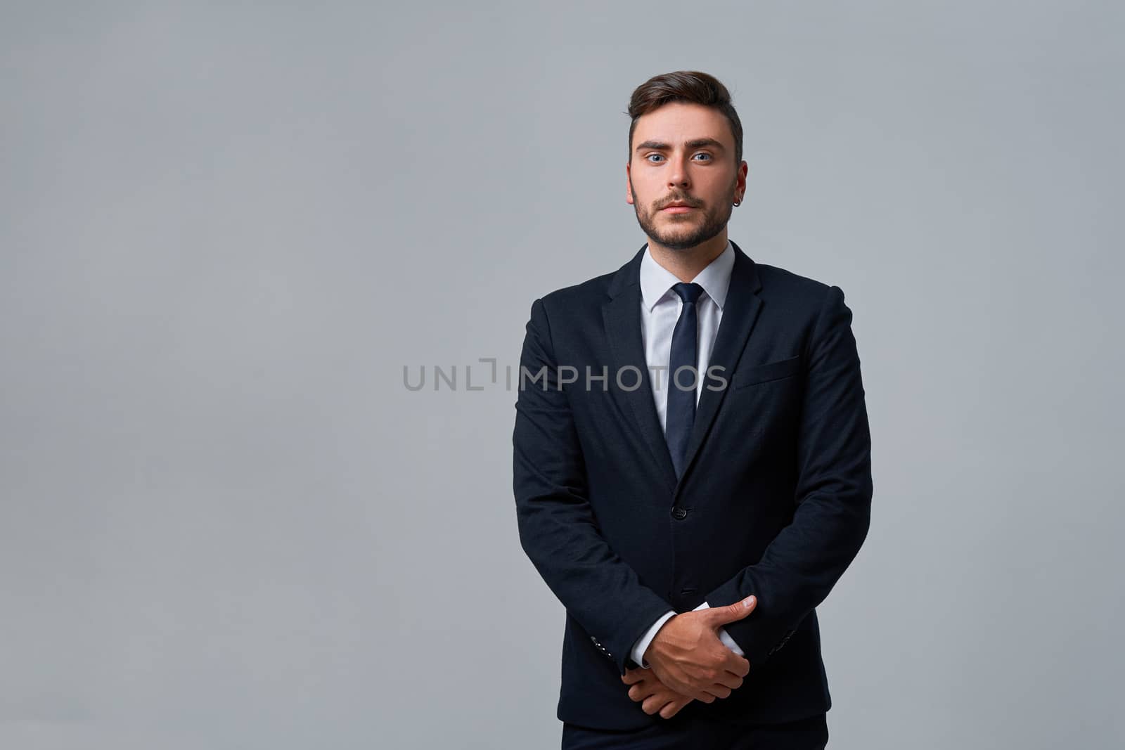 Businessman Business person. Man business suit studio gray background. Modern millenial person stylish haircut earring in ear. Portrait of charming successful young entrepreneur