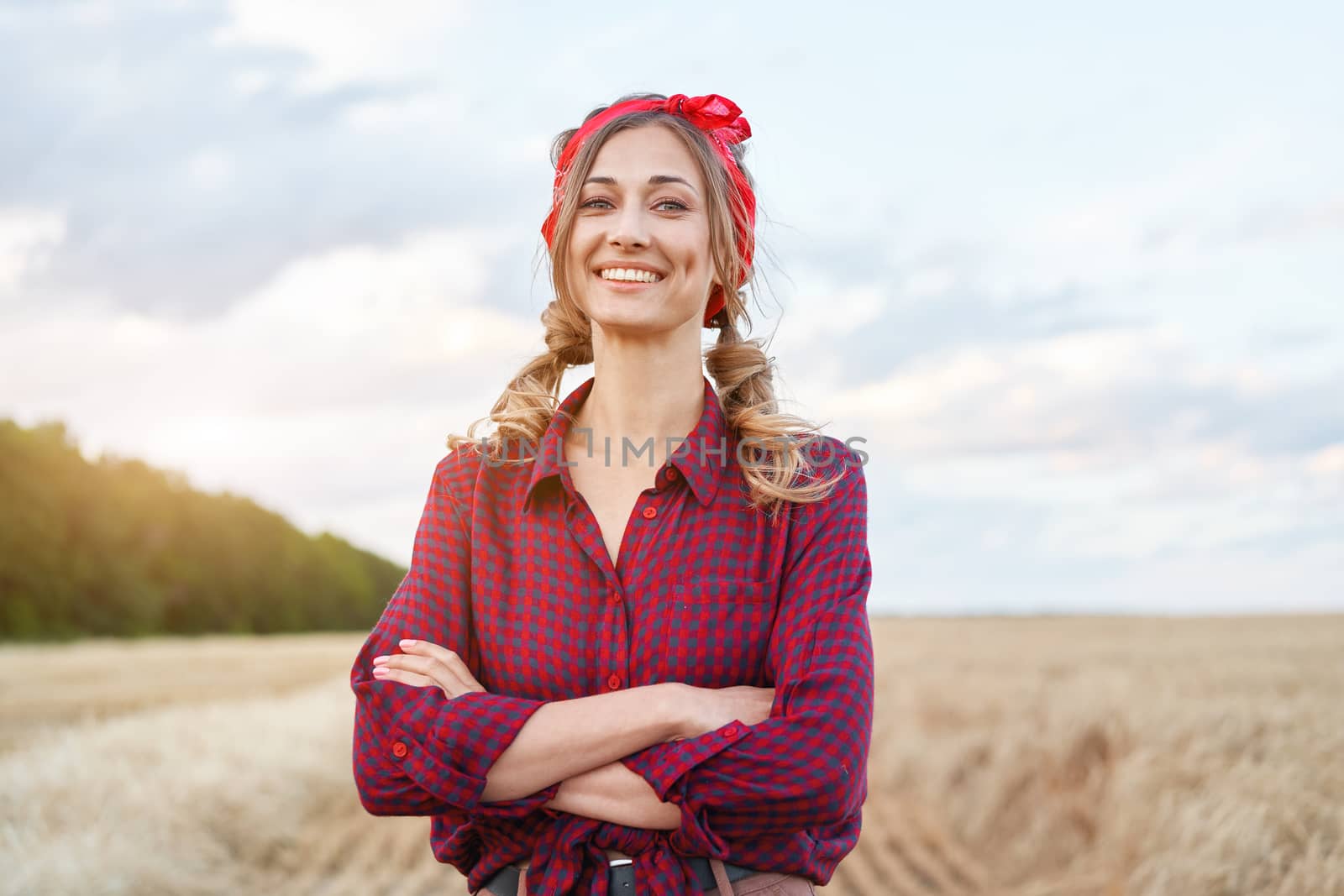 Woman farmer standing farmland smiling Female agronomist specialist farming agribusiness Happy positive caucasian worker agricultural field dressed red checkered shirt and bandana arms crossed
