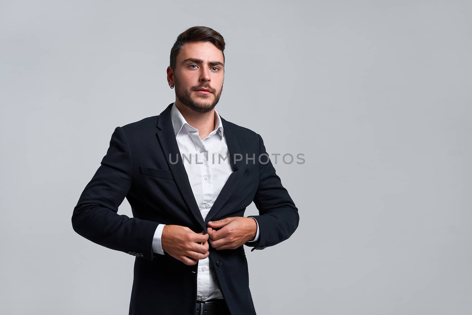 Businessman Business person. Man business suit studio gray background. Modern business person Buttons buttons on a jacket. Portrait of charming successful young entrepreneur