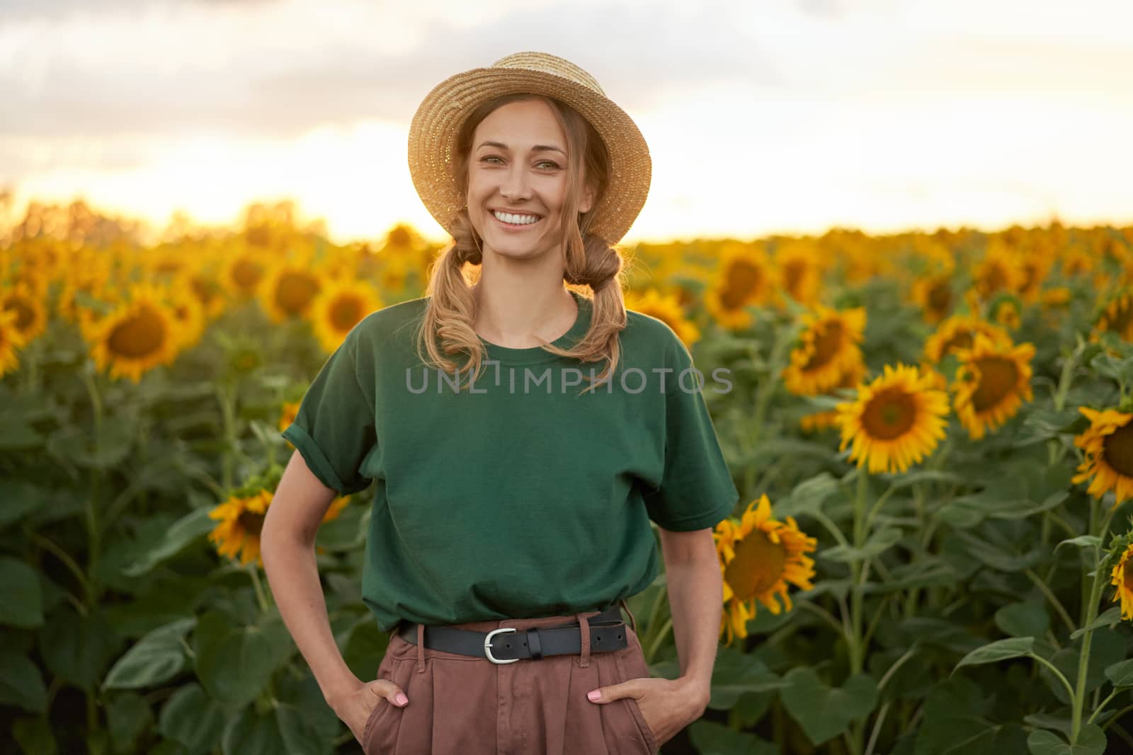 Woman agronomist standing agricultural sunflower field Caucasian female farmer straw hat Portrait agribusiness worker by andreonegin