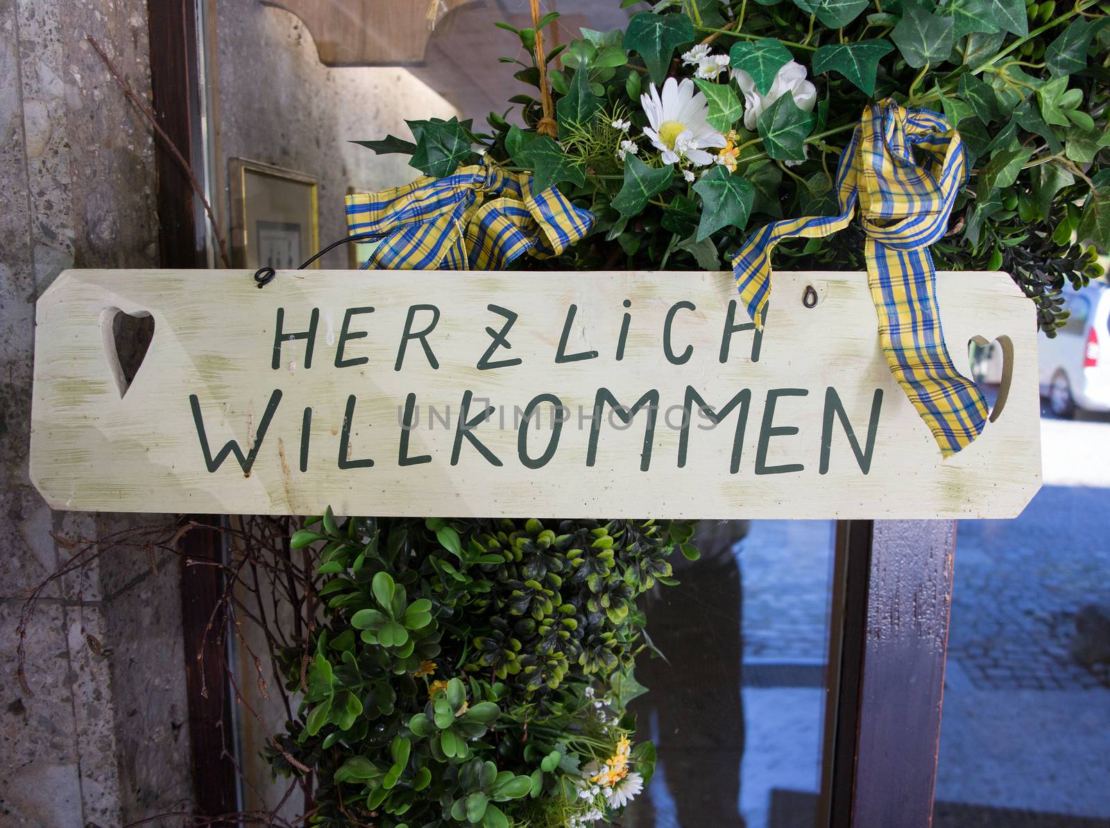 German "Herzlich willkommen" sign translates into "Hearty Welcome" in English by Kasparart