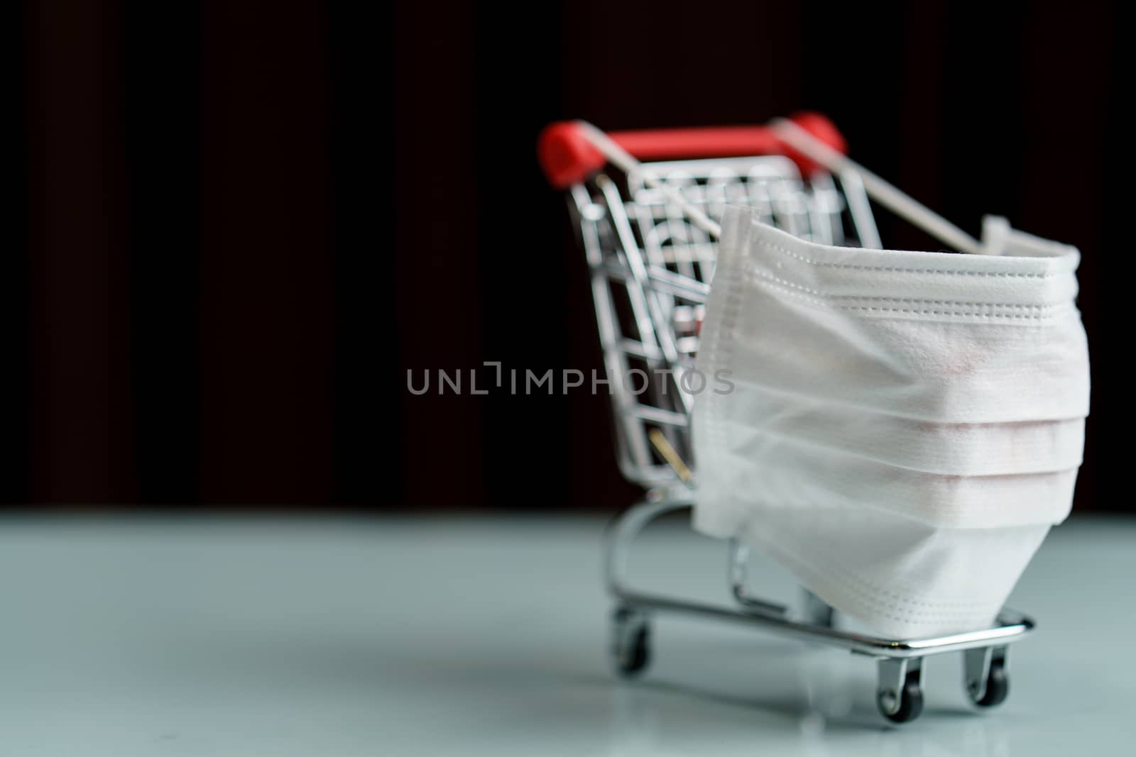 Shopping cart with protective face mask corona virus or Covid-19 by sirawit99