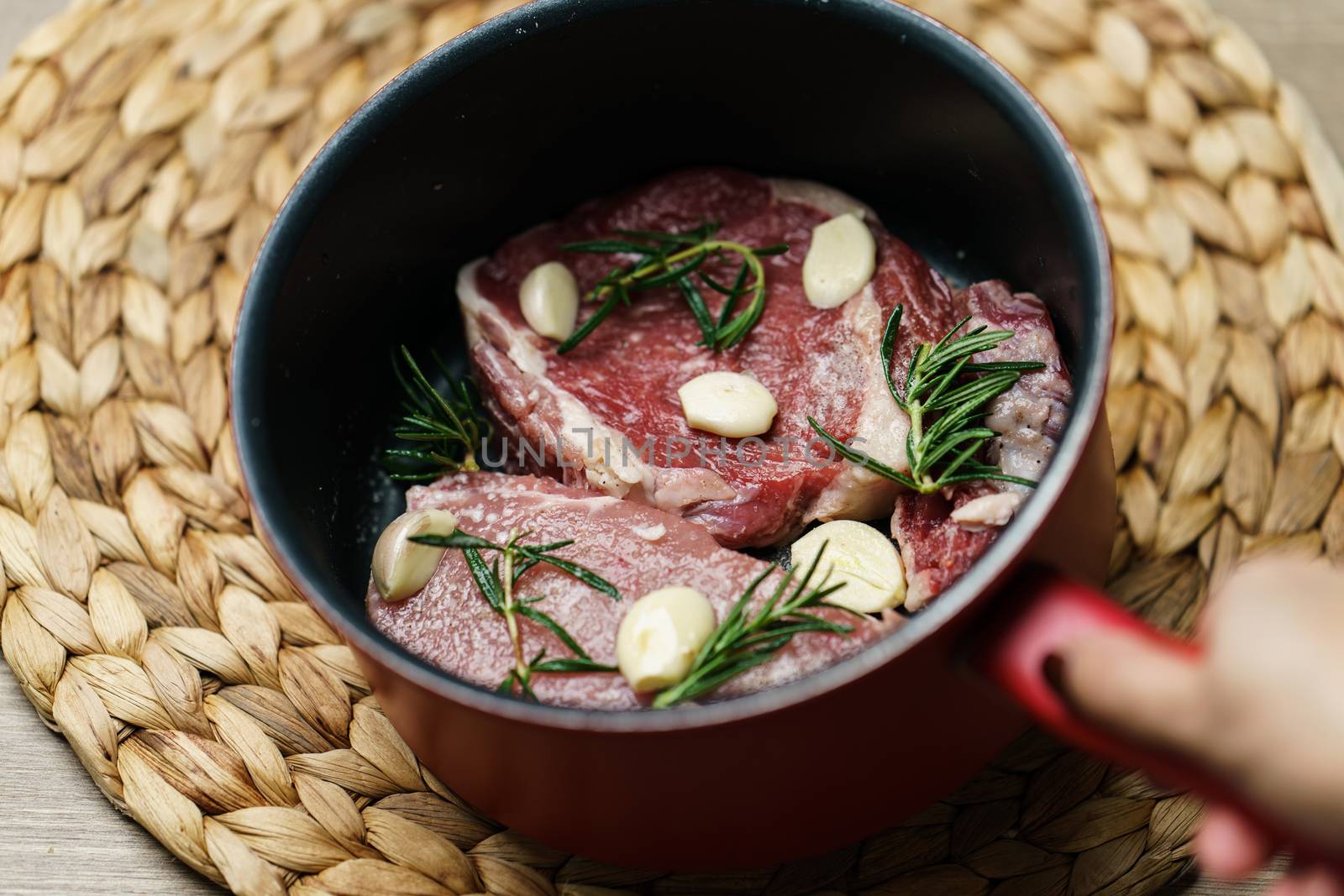 Raw beef steak and pork juicy steak with vegetables and spices in the pan.