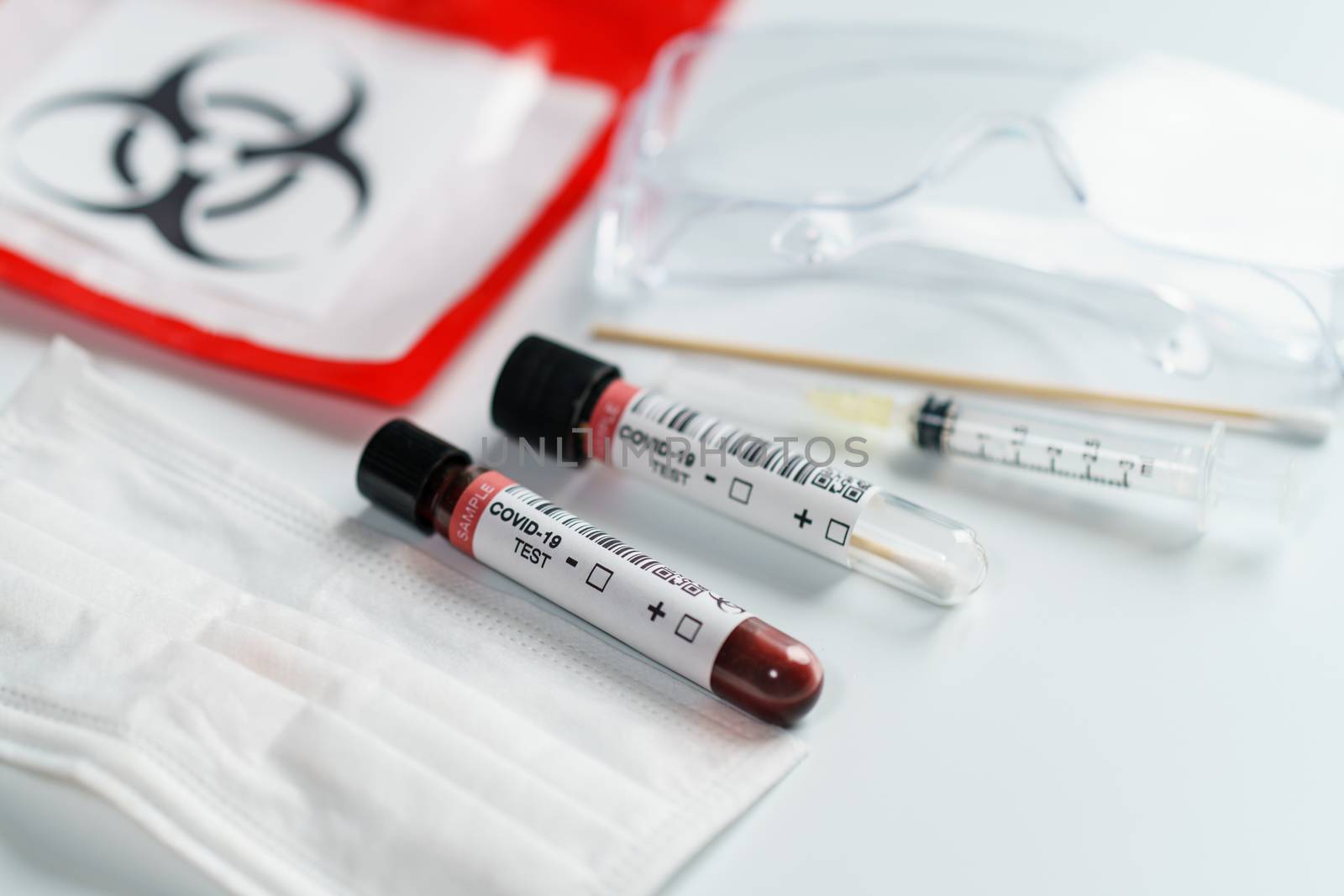 Blood test samples tube, reagent testing tube and swab collection kit in the laboratory, Coronavirus testing process. (Fake QR code and barcode)