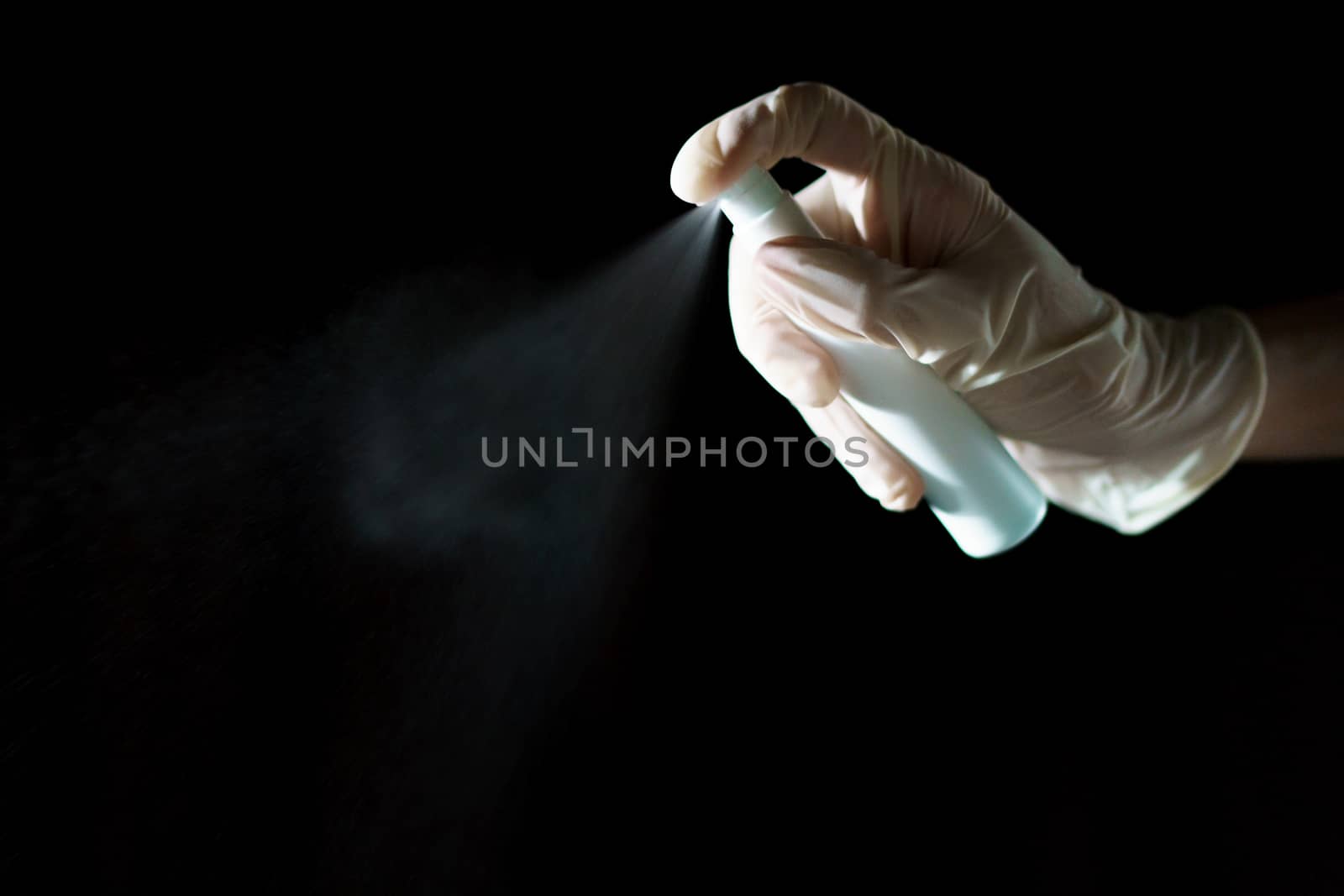 Hand using sanitizer spray, alcohol spraying disinfectant to stop spreading coronavirus or COVID-19.