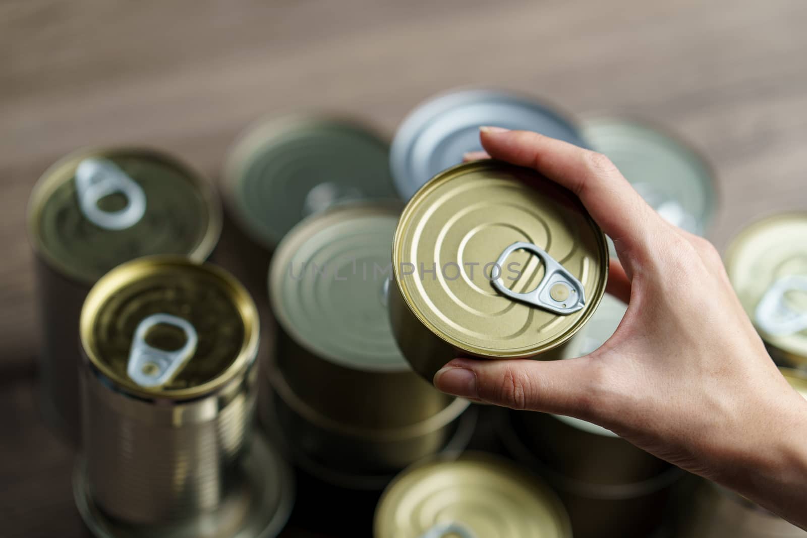 Woman hand with group of Aluminium canned food. by sirawit99