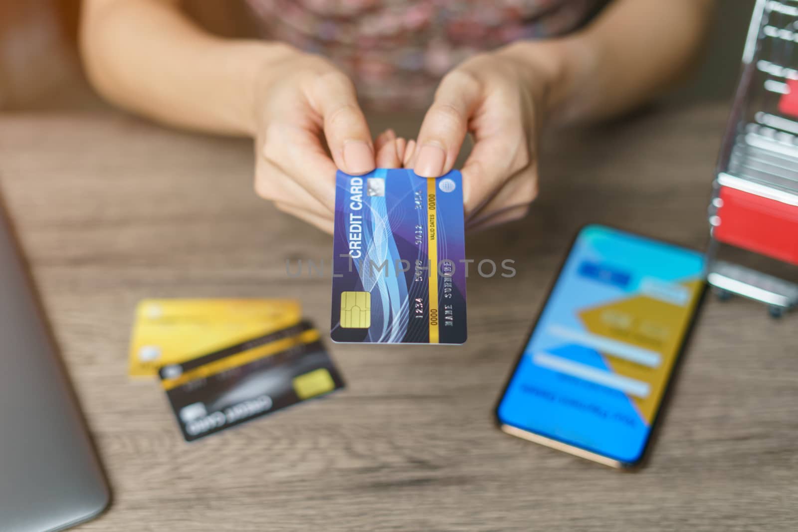 Woman is paying using a credit card, shopping and retail concept