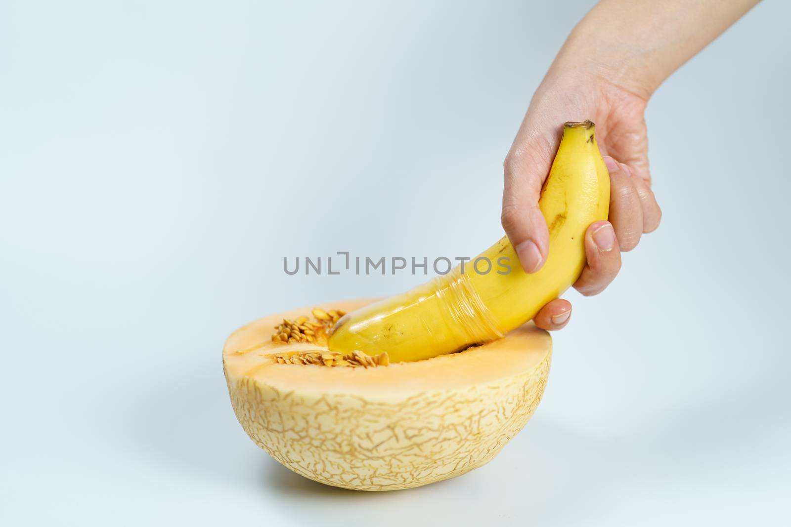 Melon and banana with condom on white background, Sex concept. by sirawit99