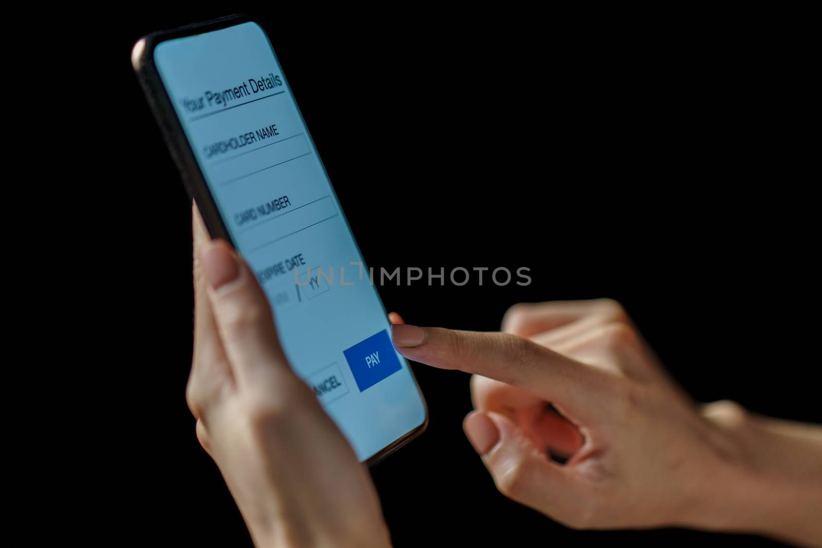 Woman hand holding smartphone. Payment or play. (Fake Screen)