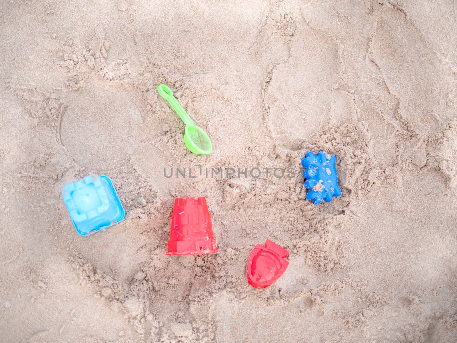 Top view Children's toys on the sand beach. Toys for summer holiday backgrounds.