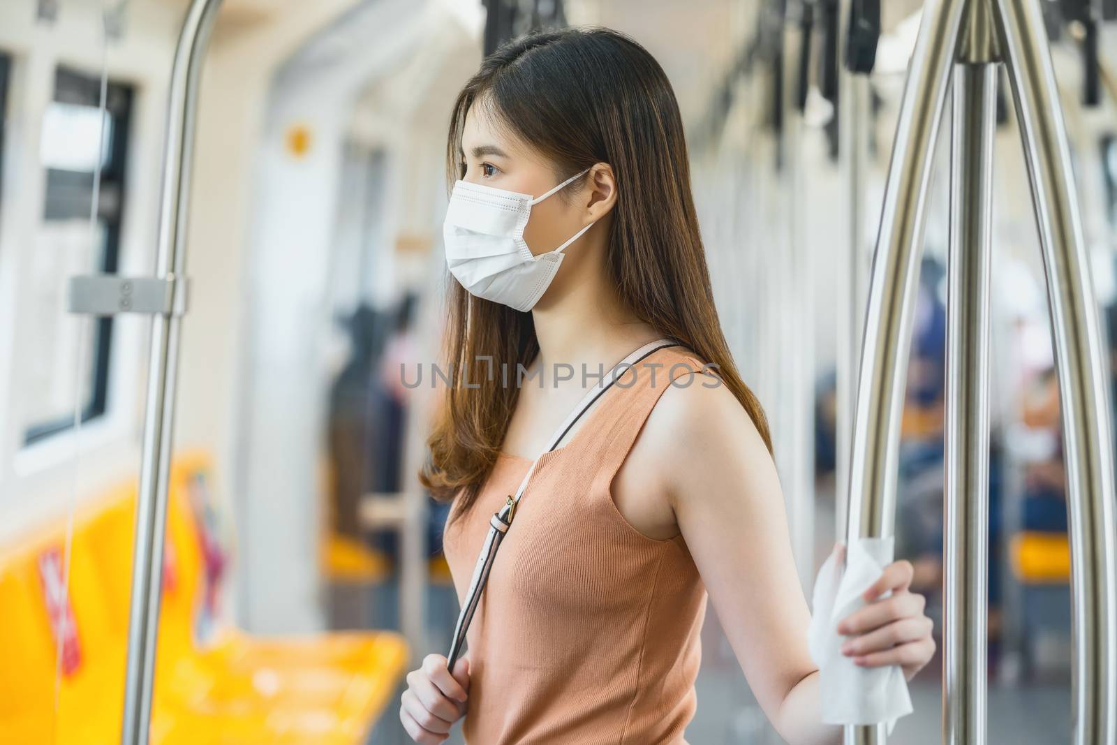 Young Asian woman passenger wearing surgical mask and hand touch by Tzido