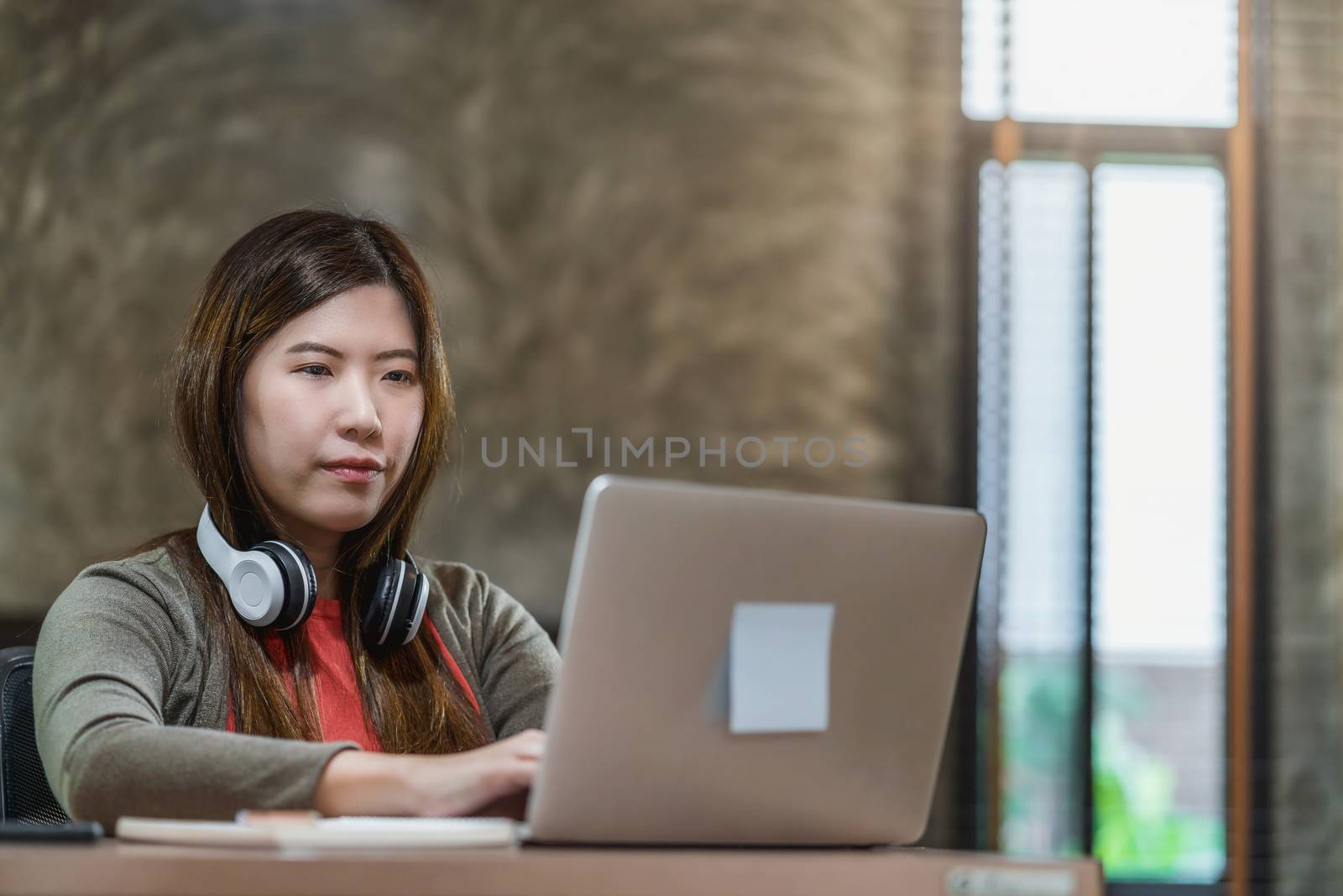 Asian business woman using technology laptop and working from home in indoor bedroom,freelance and entrepreneur,startups and business owner,lifestyle occupation,social distance and self responsibility