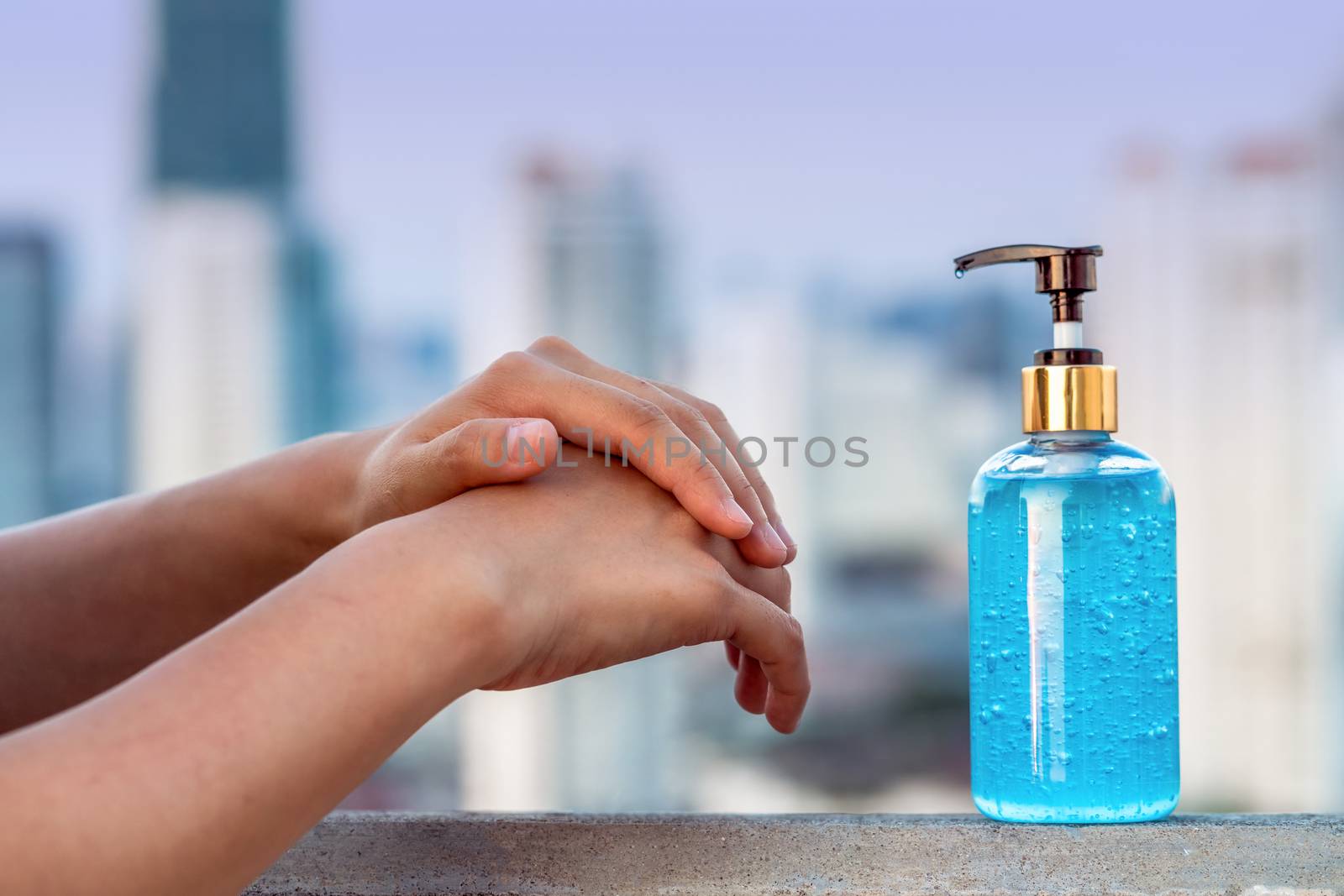 Closeup Asian woman hand using wash hand sanitizer gel pump disp by Tzido