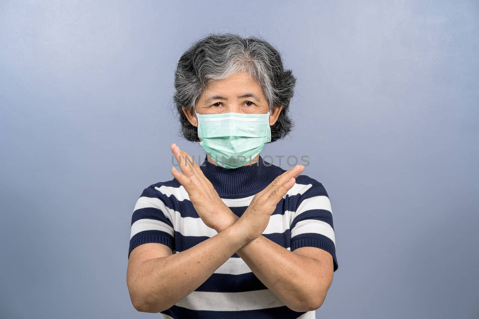 Portrait of asian old woman wearing face surgical mask and say n by Tzido