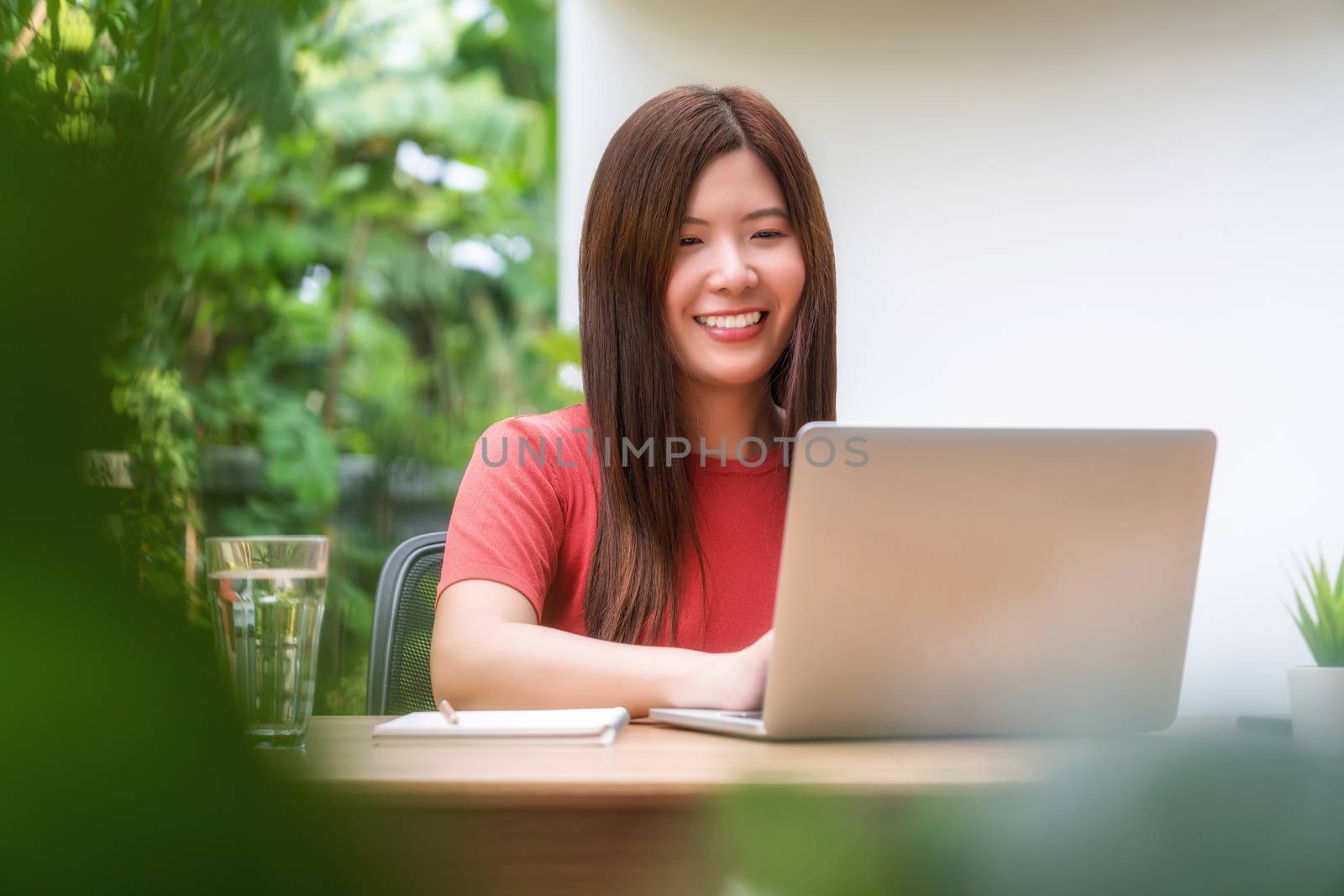 Asian business woman using technology laptop for working from home in outdoor home and garden, startups and business owner, covid19 social distance and self responsibility with quarantine concept